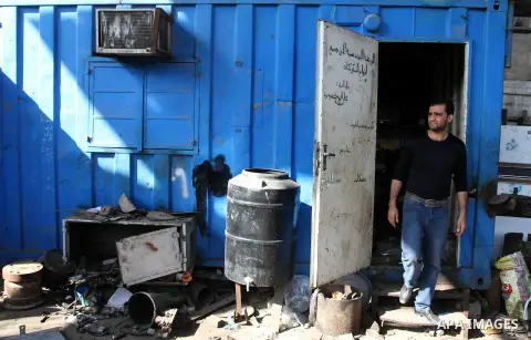 A Palestinian man inspects his workshop following an overnight Israeli air strike on Jabalia in the northern Gaza Strip, on April 4, 2014. After Israel called off the planned release of 26 Palestinian prisoners the day b...