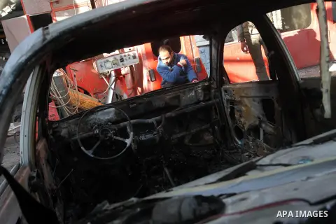 A Palestinian man inspects a burnt out car following an overnight Israeli air strike on Jabalia in the northern Gaza Strip, on April 4, 2014. After Israel called off the planned release of 26 Palestinian prisoners the da...