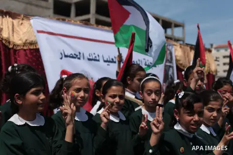 Palestinian children take part in a rally marking the Children's Day during a protest against Israeli blockade on Gaza strip in Gaza city, on April 05, 2014. Photo by Ashraf Amra