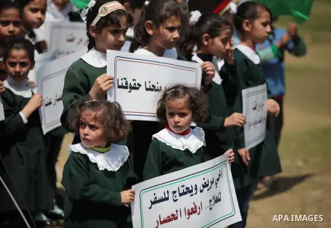 Palestinian children take part in a rally marking the Children's Day during a protest against Israeli blockade on Gaza strip in Gaza city, on April 05, 2014. Photo by Ashraf Amra