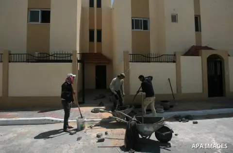 Palestinian construction workers build a new residential buildings in the Saudi neighborhood project at Rafah in southern Gaza strip, on April 05, 2014. Funded by the Saudi Fund for Development under the supervision of t...