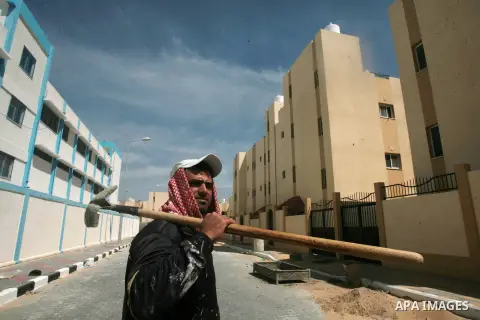 A Palestinian construction worker builds a new residential buildings in the Saudi neighborhood project at Rafah in southern Gaza strip, on April 05, 2014. Funded by the Saudi Fund for Development under the supervision of...