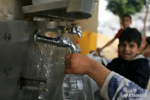 Palestinian children fill water from public pipes provided by the United Nations Relief and Works Agency (UNRWA, in Rafah refugee camp in the southern Gaza Strip on April 7, 2014. Some 95 percent of water in the water ta...