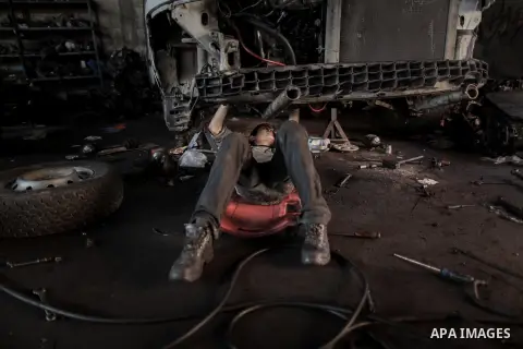 Twelve-year-old Palestinian boy Mahmoud shaaban works in a car workshop in Gaza City on April 7, 2014. There are about 65,000 working children in the Palestinian territories, accounting for 6% of all children at 5-14, ac...
