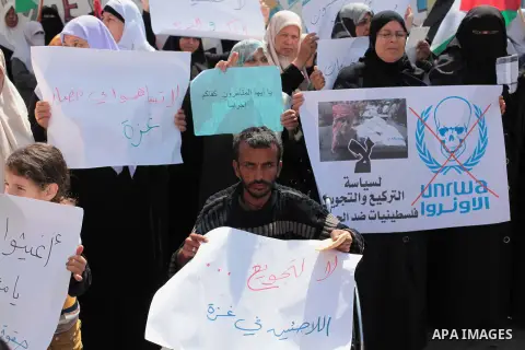 Palestinian women take part in a protest against the decision made by the United Nations Relief and Works Agency (UNRWA) to reduce food aid delivered to the Gaza Strip in front of the UNRWA headquarters in Gaza City on A...