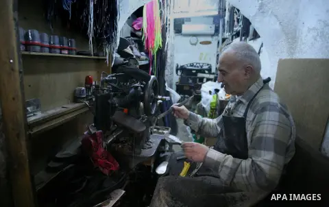 A Palestinian shoemaker works at his workshop in Jerusalem's old city, April 09, 2014. Arab foreign ministers met with Abbas to discuss floundering US-brokered peace talks with Israel ahead of a looming deadline. Abbas r...