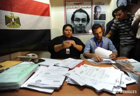 Egyptian employees recieve the authorization signatures for the nomination process from supporters of Egyptian presidential hopeful, leftist, Hamdeen Sabahi, at a registration office, in Beni Suef southern Cairo, April 1...