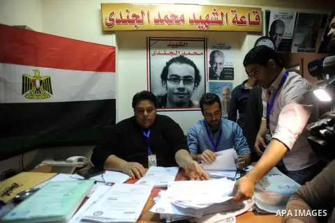 Egyptian employees recieve the authorization signatures for the nomination process from supporters of Egyptian presidential hopeful, leftist, Hamdeen Sabahi, at a registration office, in Beni Suef southern Cairo, April 1...