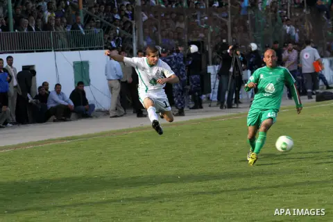 Palestinian players of Rafah and Shija'a teams compete during their final soccer match in a local competition, at al-Yarmouk stadium in Gaza City April 11, 2014. Photo by Mohammed Asad