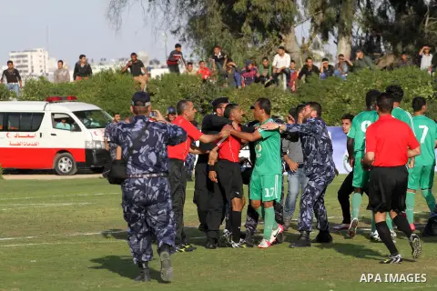 Palestinian players of Rafah and Shija'a teams compete during their final soccer match in a local competition, at al-Yarmouk stadium in Gaza City April 11, 2014. Photo by Mohammed Asad