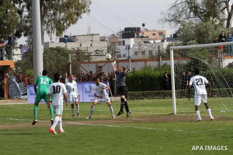 Palestinian players of Rafah and Shija'a teams compete during their final soccer match in a local competition, at al-Yarmouk stadium in Gaza City April 11, 2014. Photo by Mohammed Asad