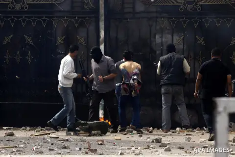 Armed plainclothes policemen try to enter the gate of Ain Shams University during clashes with students who are supporters of the Muslim Brotherhood and ousted President Mohamed Mursi, following a protest against former...
