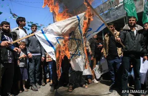 Palestinians burn the Israeli flag during a rally to show solidarity with al-Aqsa mosque, in Rafah in the southern Gaza Strip April 14, 2014. The Palestinian presidency warned on Sunday against the continuous breaking in...