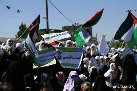 Palestinians hold Palestine flags during a rally to show solidarity with al-Aqsa mosque, in Khan Younis in the southern Gaza Strip April 14, 2014. The Palestinian presidency warned on Sunday against the continuous breaki...