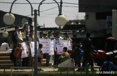 Palestinians hold banners in a rally marking Palestinian Prisoner Day, in Rafah in southern Gaza strip April 17, 2014. Israel holds some 5,000 Palestinians it accuses of committing or planning violence against it. Photo...