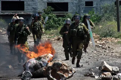 Israeli security forces run after Palestinian protesters during clashes following a weekly protest against the expropriation of Palestinian land by Israel in the village of Kfar Qaddum, near Nablus, in the occupied West...