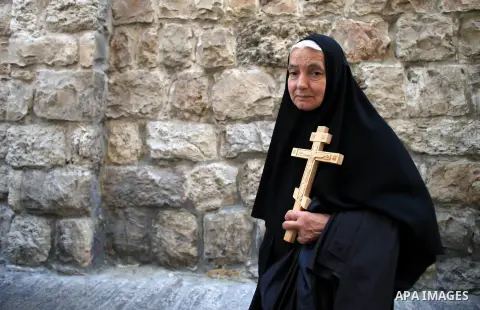 Christian Orthodox pilgrims participate in a procession marking Good Friday on April 18, 2014 in Jerusalem's old city. Thousands of Christian pilgrims take part in processions along the route where, according to traditio...