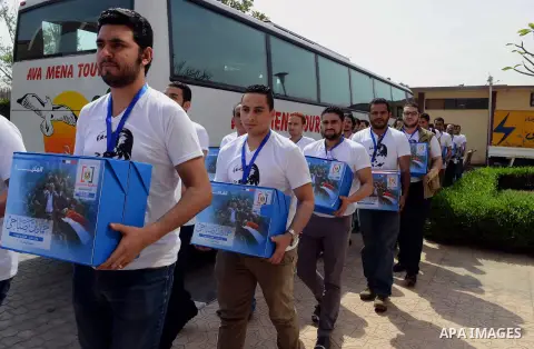 Campaign volunteers of presidential hopeful Hamdeen Sabahi, carry boxes containing thousands of endorsements at the election commission office in Cairo, Egypt, Saturday, April 19, 2014. It is mandatory for any presidenti...