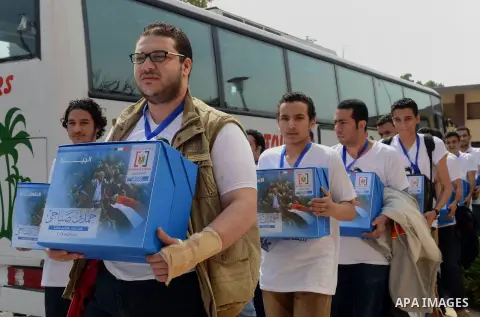 Campaign volunteers of presidential hopeful Hamdeen Sabahi, carry boxes containing thousands of endorsements at the election commission office in Cairo, Egypt, Saturday, April 19, 2014. It is mandatory for any presidenti...