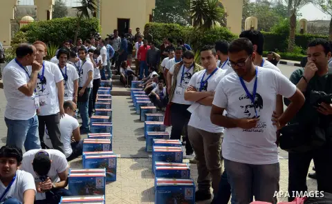 Campaign volunteers of presidential hopeful Hamdeen Sabahi, carry boxes containing thousands of endorsements at the election commission office in Cairo, Egypt, Saturday, April 19, 2014. It is mandatory for any presidenti...