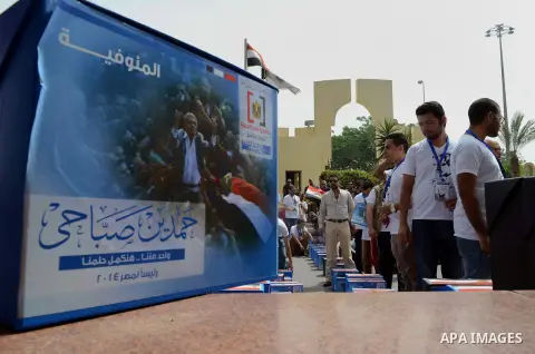 Campaign volunteers of presidential hopeful Hamdeen Sabahi, carry boxes containing thousands of endorsements at the election commission office in Cairo, Egypt, Saturday, April 19, 2014. It is mandatory for any presidenti...