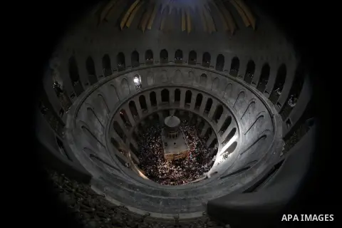 Christian pilgrims hold candles at the church of the Holy Sepulcher, traditionally believed to be the burial site of Jesus Christ, during the ceremony of the Holy Fire in Jerusalem's Old City, Saturday, April 19, 2014. T...