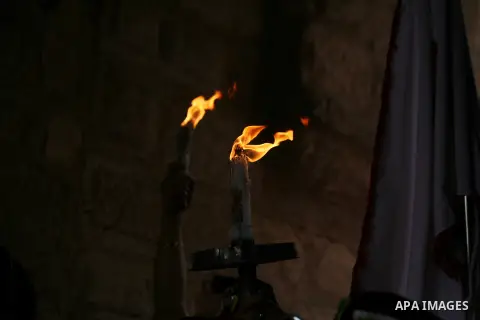 Christian pilgrims hold candles at the church of the Holy Sepulcher, traditionally believed to be the burial site of Jesus Christ, during the ceremony of the Holy Fire in Jerusalem's Old City, Saturday, April 19, 2014. T...