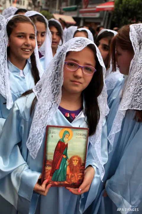 Palestinian Christians children take part in a procession a day before Orthodox Easter in the West Bank city of Ramallah on April 19, 2014. Photo by Issam Rimawi