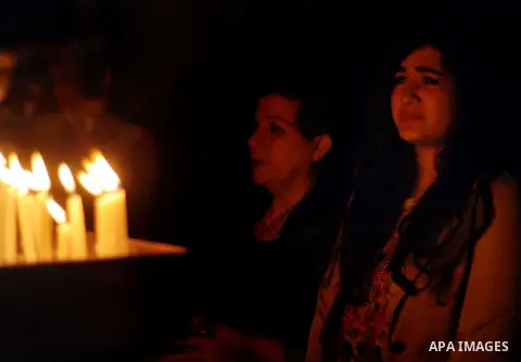 Palestinian Orthodox Christians hold candles during the ceremony of the Holy Fire at the Saint Porfirios church in Gaza City early Gaza City on April 20, 2014. Photo by Mohammed Talatene
