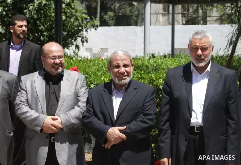 Palestinian Prime Minister in Gaza Strip, Ismail Haniyeh waves outside his office in Gaza City April 21, 2014. Leaders of the Hamas-controlled Gaza Strip are scheduled to take part in unity talks with the rival Fatah mov...