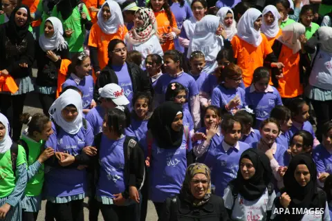Palestinian girls take part in Al- Shaymaa campaign during a rally in the West Bank city of Hebron, on April 21, 2014. About 7000 students participate in the campaign to save lives by increasing awareness of breast cance...