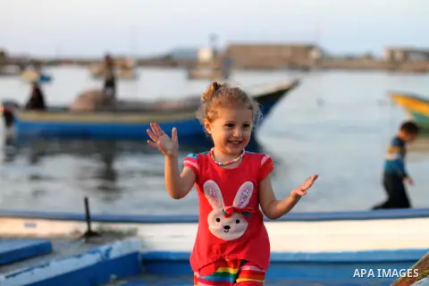A Palestinian girl plays at the seaport during the sunset, in Gaza City on April 25, 2014. Israel said it was halting negotiations with the Palestinians following their unity deal with the Hamas rulers of Gaza, as falter...
