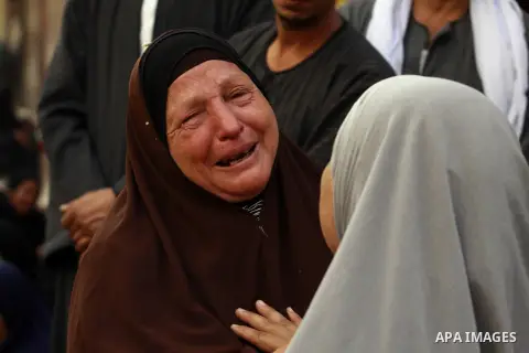 Relatives and families of members of Muslim Brotherhood and supporters of ousted President Mohamed Mursi react after hearing the sentence, in front of the court in Minya, south of Cairo, April 28, 2014. An Egyptian court...