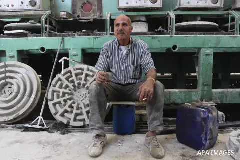 A Palestinian labourer drink tea at Al-shamaly Tile factory, in Gaza city May 01, 2014. to mark the International Labor Day. According to the United Nations Office for the Coordination of Humanitarian Affairs, the unempl...