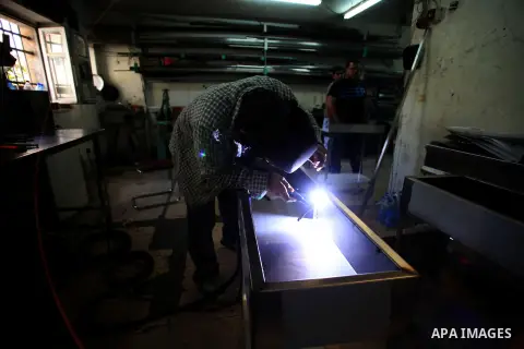 A Palestinian blacksmith works at his workshop, during the International Workers' Day, in Jerusalem May 1, 2014. Photo by Saeed Qaq