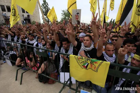 Palestinian supporters of the Fatah movement attend a rally prior to the Student Council elections at Birzeit University, on the outskirts of the city of Ramallah in the West Bank on May 6, 2014. The Student Council elec...