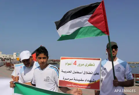 Palestinians hold banners during a rally marking the fourth anniversary of attack on the Turkish flotilla Mavi Marmara at Gaza seaport on May 11, 2014. Turkey broke off diplomatic relations with Israel in 2010, after the...
