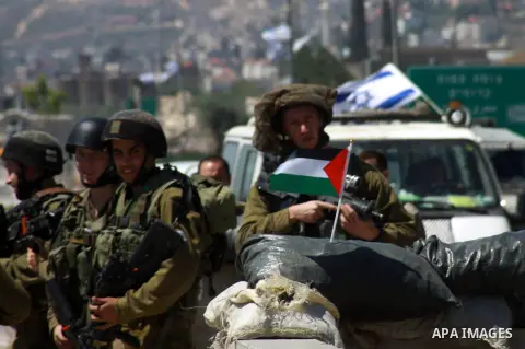 Israeli soldiers scuffle with Palestinian protesters holding Palestinian flags during a protest ahead of the 66th anniversary of Nakba, at Hawara checkpoint near the West Bank City of Nablus May 14, 2014. Palestinians wi...