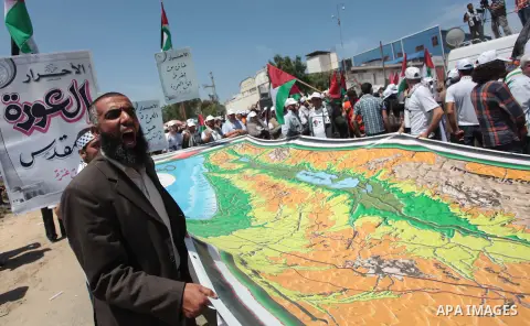 Palestinian protesters take part in a rally marking the Nakba or the ''Day of Catastrophe'' near Erez crossing in the northern Gaza Strip on May 15, 2014. Palestinians marked "Nakba" (Catastrophe) on Thursday to commemor...