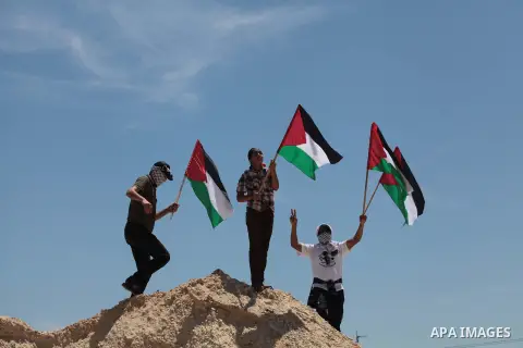 Palestinian protesters take part in a rally marking the Nakba or the ''Day of Catastrophe'' near Erez crossing in the northern Gaza Strip on May 15, 2014. Palestinians marked "Nakba" (Catastrophe) on Thursday to commemor...