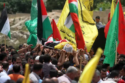 Palestinian mourners carry the bodies of two Palestinians, Nadim Nuwara, and Mohammad Abu Daher, who were shot dead by Israeli forces on Thursday, during their funeral in the West Bank city of Ramallah on Friday, May 16,...
