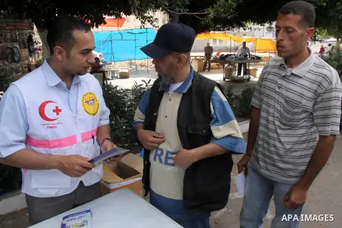Palestinian men measure the blood pressure on the occasion of the World Day Pressure, in Gaza city on May 17, 2014. Palestinian Medical Relief Society in Gaza strip organized an awareness campaign of the dangers of high...