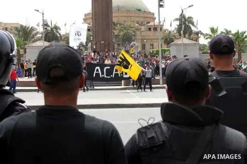 Egyptian security forces take up position during as supporters of ousted President Mohammed Morsi protest outside Cairo University in Giza, near Cairo, May 20, 2014. Security forces used tear gas to disperse students who...