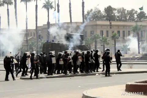 Egyptian security forces fire tear gas towards supporters of ousted President Mohammed Morsi during a demonstration outside Cairo University in Giza, near Cairo, May 20, 2014. Security forces used tear gas to disperse st...