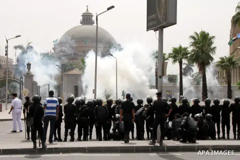 Egyptian security forces fire tear gas towards supporters of ousted President Mohammed Morsi during a demonstration outside Cairo University in Giza, near Cairo, May 20, 2014. Security forces used tear gas to disperse st...