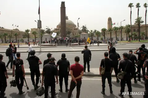 Egyptian security forces take up position during as supporters of ousted President Mohammed Morsi protest outside Cairo University in Giza, near Cairo, May 20, 2014. Security forces used tear gas to disperse students who...