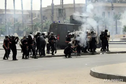 Egyptian security forces fire tear gas towards supporters of ousted President Mohammed Morsi during a demonstration outside Cairo University in Giza, near Cairo, May 20, 2014. Security forces used tear gas to disperse st...