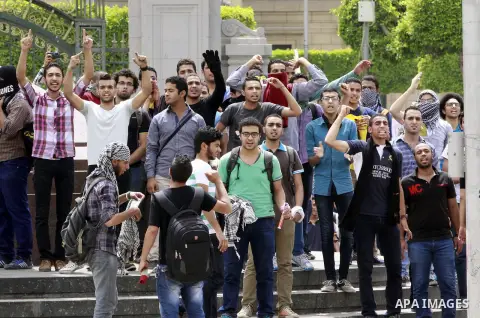 Egyptian supporters of ousted President Mohammed Morsi chant slogans during a demonstration outside Cairo University in Giza, near Cairo, May 20, 2014. Students who took their protest outside the campus Wednesday clashed...