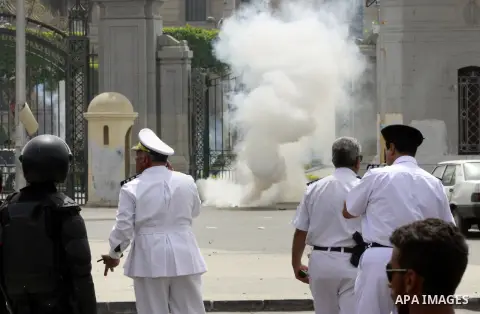 Egyptian security forces fire tear gas towards supporters of ousted President Mohammed Morsi during a demonstration outside Cairo University in Giza, near Cairo, May 20, 2014. Security forces used tear gas to disperse st...
