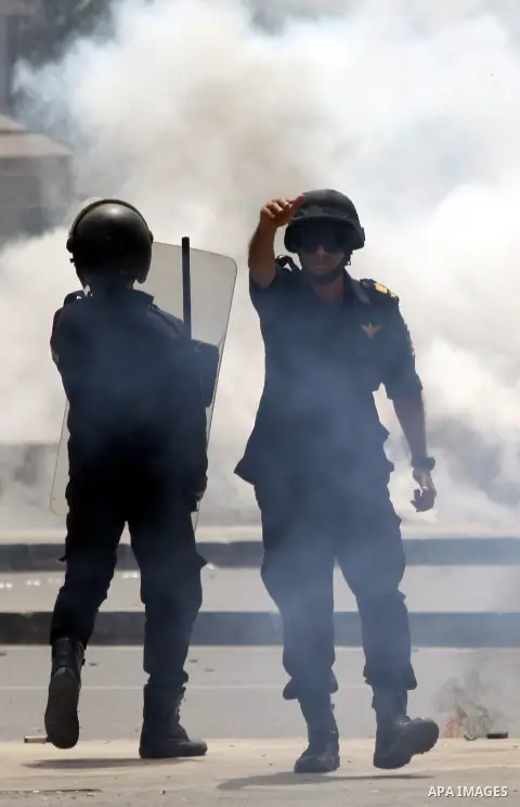 Egyptian security forces take up position during as supporters of ousted President Mohammed Morsi protest outside Cairo University in Giza, near Cairo, May 20, 2014. Security forces used tear gas to disperse students who...